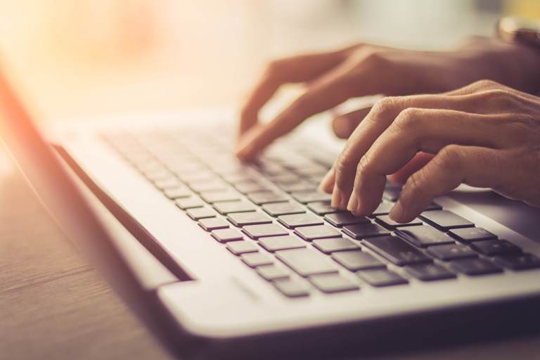 mans hands typing on keyboard